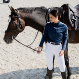 Woman stands next to horse wearing the Toggi Ladies Montagu Base Layer in Midnight Navy Print