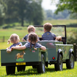 Children sit in small trailer wearing the Shires Childrens Winnie & Me T-shirt in Navy Stripe