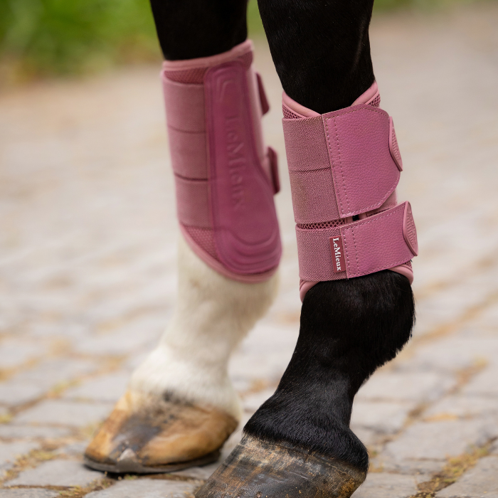 Horse's legs wearing the LeMieux Arika Mesh Brushing Boots in Peony