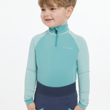 Young boy wears the LeMieux Mini Base Layer in Lagoon