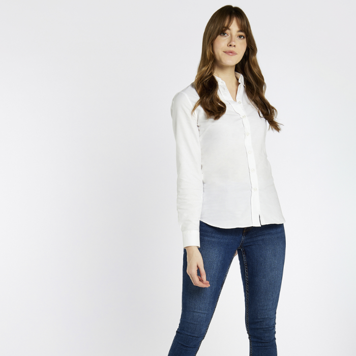 Woman wears the Dubarry Ladies Mimosa Shirt in White with blue jeans