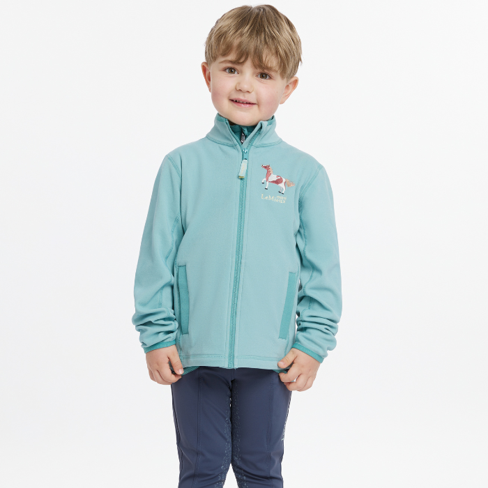 Young boy wears the LeMieux Mini Mari Micro Fleece in Aqua