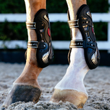 Horse wears the LeMieux EXO Flex Tendon Boots in Black/Silver on hind legs