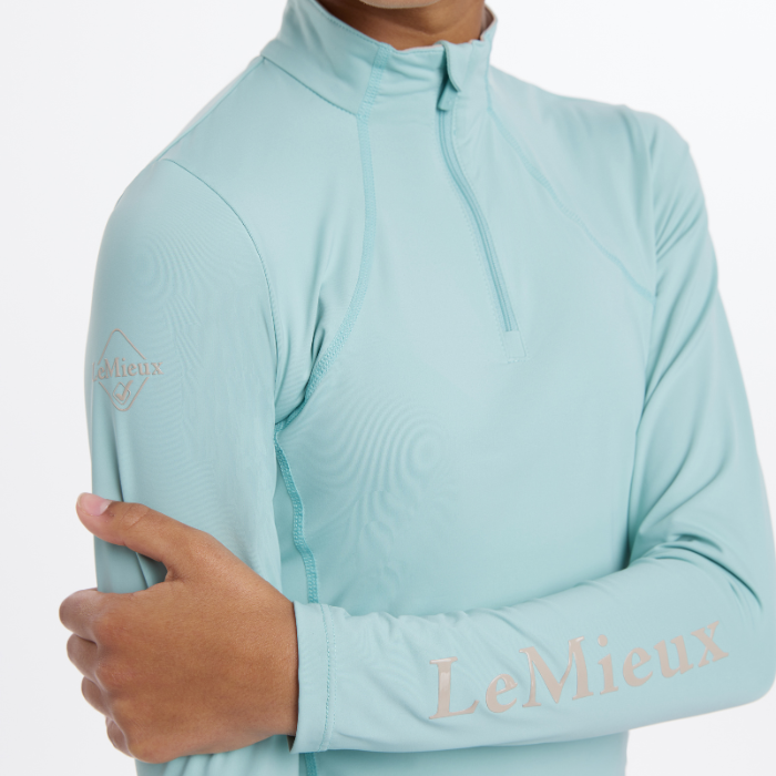 Logo sleeve detail on the LeMieux Young Riders Base Layer in aqua