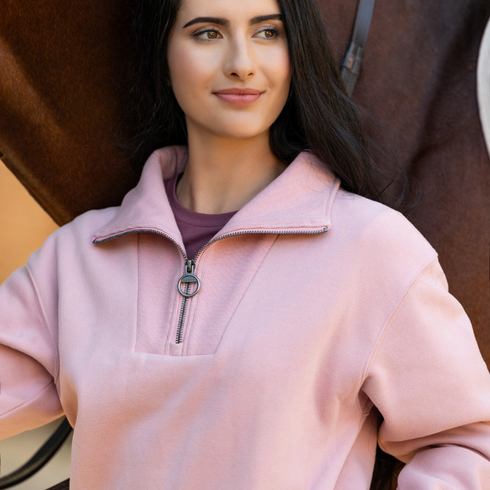 Close up of a female stood next to a horse wearing the LeMieux Ladies Kiera Quarter Neck in Blossom