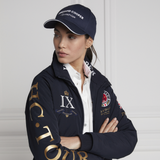 Lady wears the Holland Cooper HC Equestrian Cap in Ink Navy with the HC Team Jacket