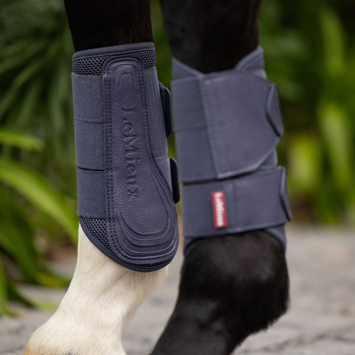 Horse's legs wearing the protective LeMieux Arika Mesh Brushing Boots in Dusk