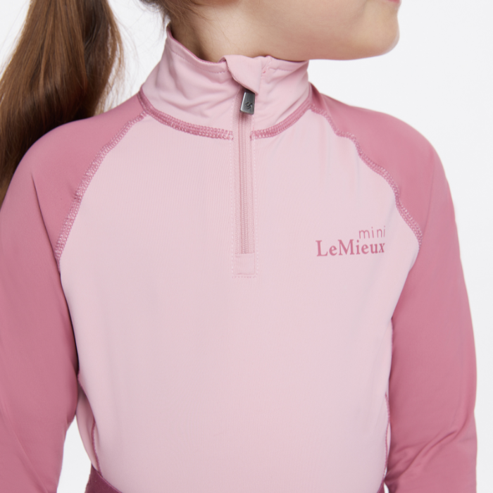 Close up logo and zip detail of the LeMieux Mini Base Layer in blossom