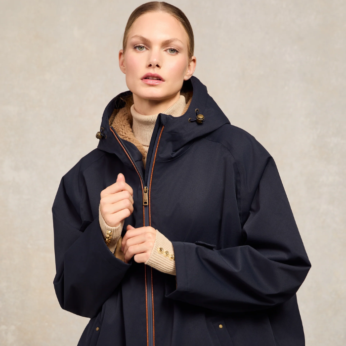 Close-up of woman wearing the Holland Cooper One-Size Waterproof Jacket in Ink Navy