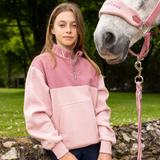 Young Rider stands with her pony wearing the LeMieux Young Riders Kate Quarter Zip in Blossom