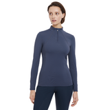 Lady stands wearing the LeMieux Ladies Base Layer in Dusk