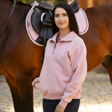 Female stands next to a bay horse wearing the LeMieux Ladies Kiera Quarter Neck in Blossom