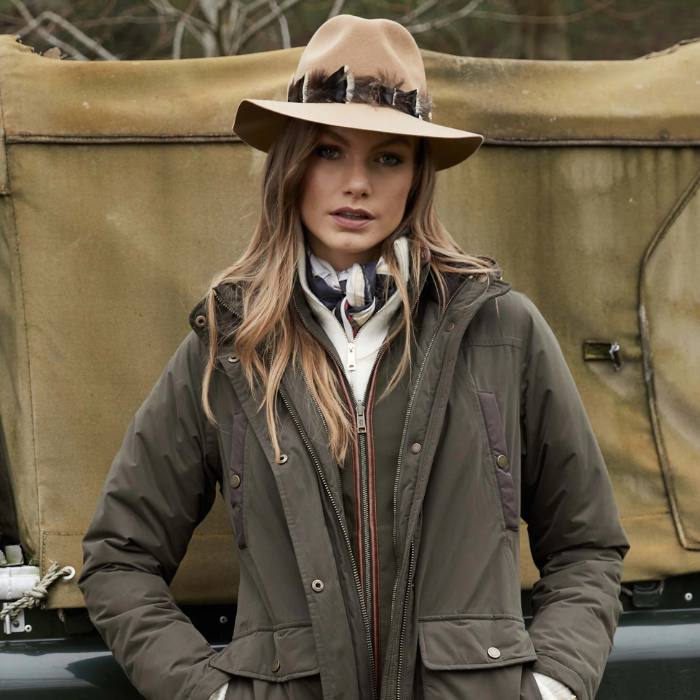 Country Lady Wears the Holland Cooper Trilby Iridescent Feather Band Hat in Camel | Eland Lodge