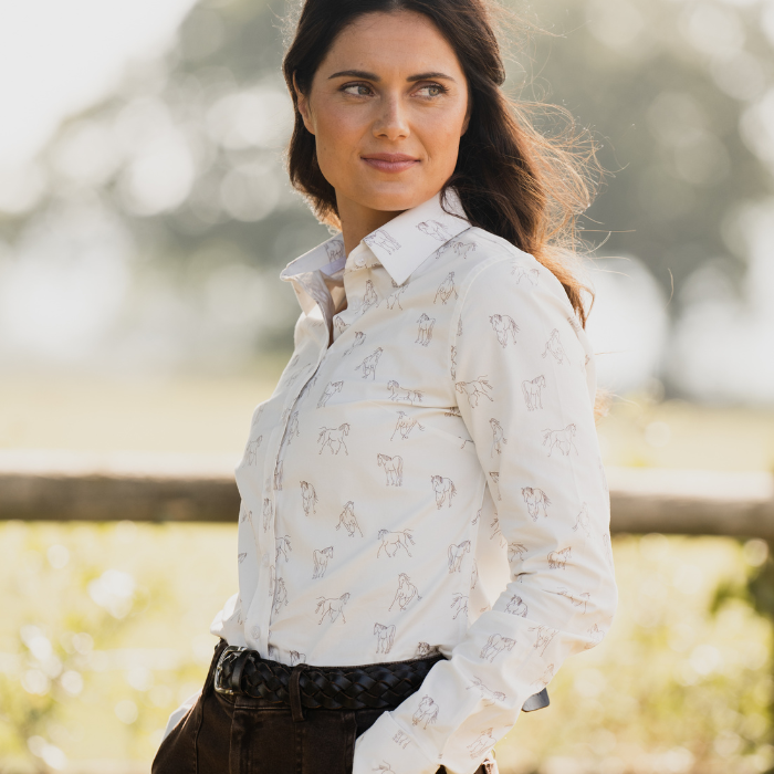 Woman outdoors wears the Toggi Ladies Eaton Shirt in White/Horse Print