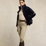 Woman wears the Holland Cooper Team Alenah Jacket in Ink Navy with beige breeches