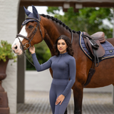 Rider stands with horse wearing the LeMieux Ladies Base Layer in Dusk