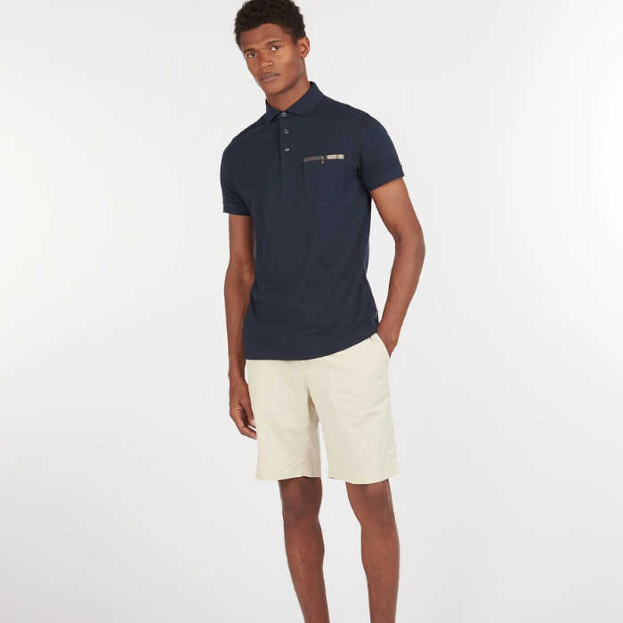 Male styles the Barbour Mens Corpatch Polo Shirt in navy with a pair of cream shorts