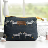 The Sophie Allport Makeup Bag with zebra print on a counter