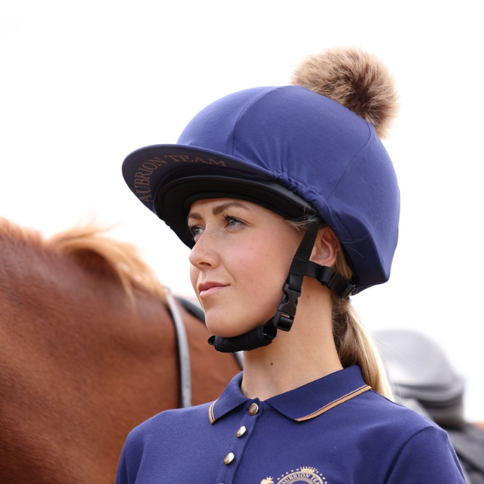 Rider wears the Shires Aubrion Team Hat Silk