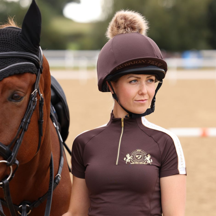 Rider wears the Shires Aubrion Team Hat Silk